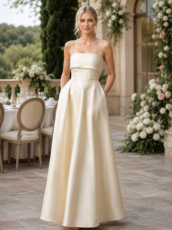 Ivory spaghetti-strap satin floor-length bridesmaid dress front view with foldover bodice and pockets