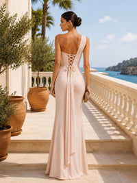 Blush champagne one-shoulder faux-silk floor-length bridesmaid dress back view with lace-up back and flowing sash
