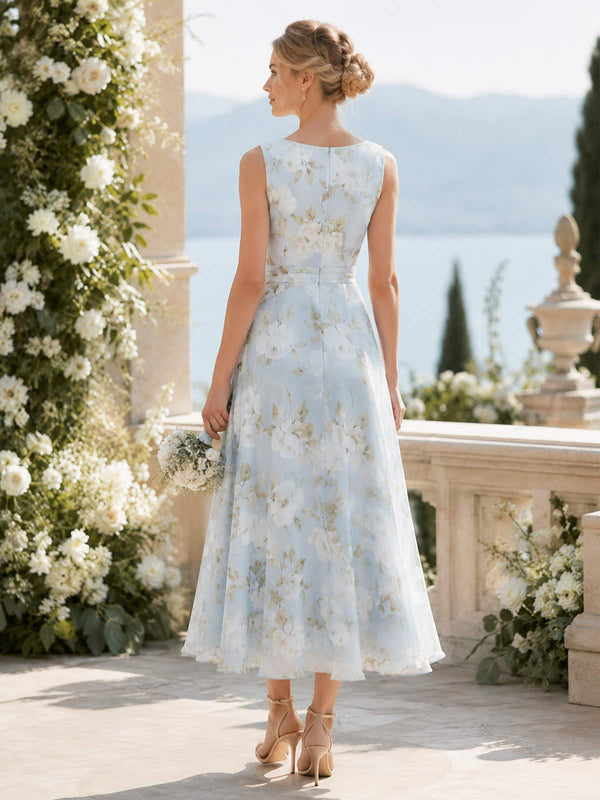 Light blue floral chiffon A-line tea-length bridesmaid dress back view with sleeveless bodice, defined waistband, and concealed zipper