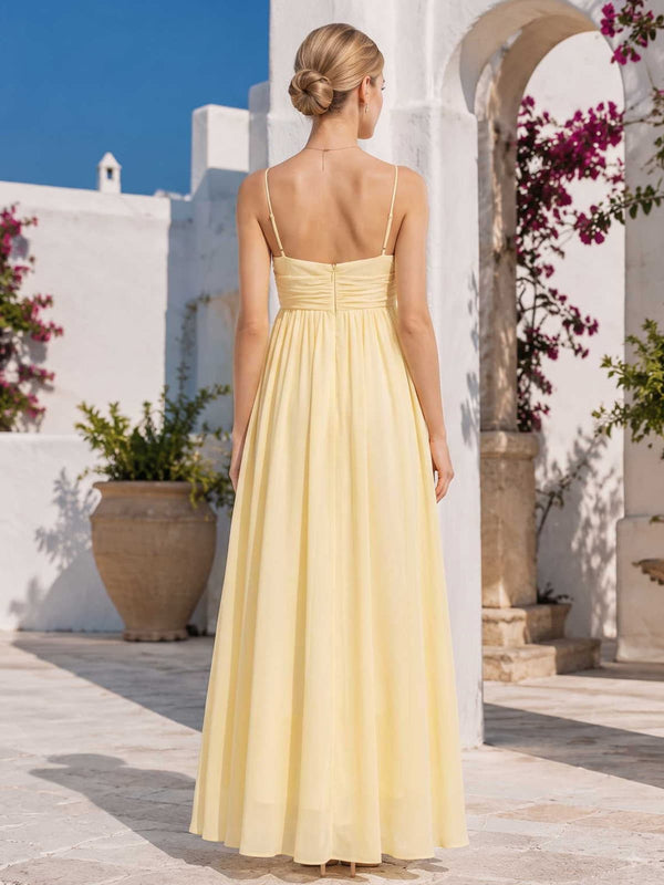 Yellow chiffon bridesmaid dress with spaghetti straps, open back, center back zipper, gathered waist, and ankle-length A-line skirt
