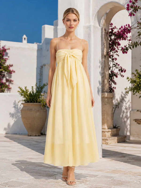 Yellow chiffon ankle-length bridesmaid dress with straight neckline, spaghetti straps, front bow detail, and flowing A-line silhouette