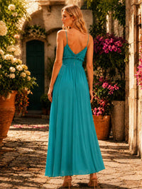 Turquoise chiffon bridesmaid dress with open V-back, spaghetti straps, smocked waist, center back zipper, and flowing floor-length A-line skirt