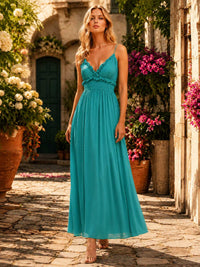 Turquoise chiffon floor-length bridesmaid dress with V-neckline, spaghetti straps, ruffle trim, smocked waist, and flowing A-line skirt