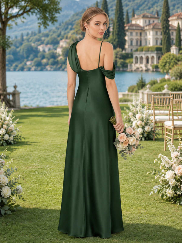 Dark green faux silk bridesmaid dress with open back, spaghetti straps, draped shoulder detail, and flowing floor-length A-line silhouette