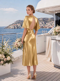 Gold faux silk bridesmaid dress with open back, flutter sleeves, center back zipper, and graceful midi-length sheath silhouette