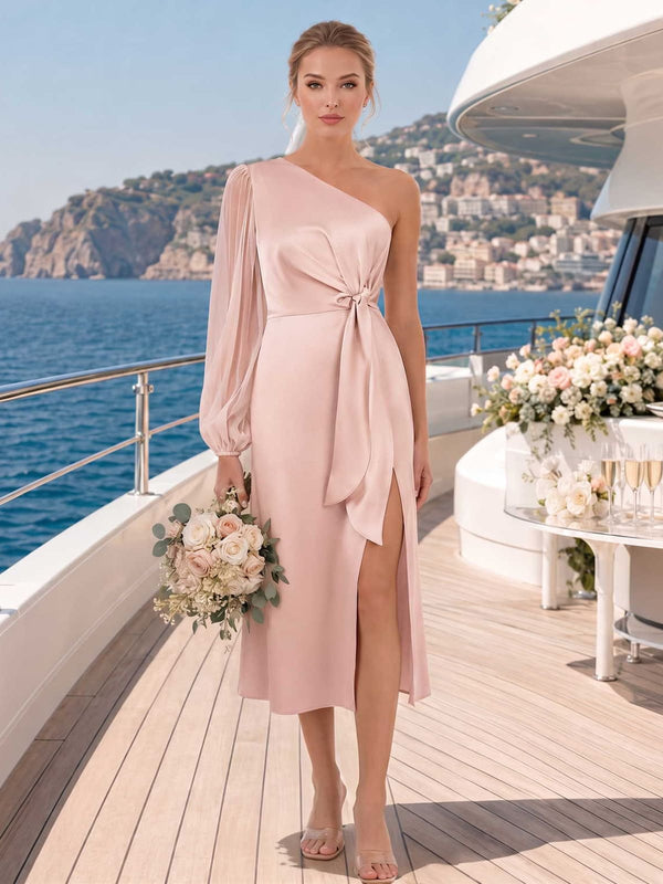 Blush faux silk bridesmaid dress with one-shoulder neckline, sheer bishop sleeve, side tie, front slit, and midi sheath skirt