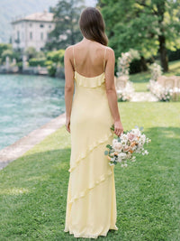 Daffodil chiffon bridesmaid dress with open back, spaghetti straps, cascading ruffle detail, and flowing floor-length sheath silhouette