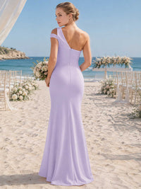 Lavender chiffon bridesmaid dress with asymmetric open back, one-shoulder strap detail, fitted waist, and flowing floor-length hem