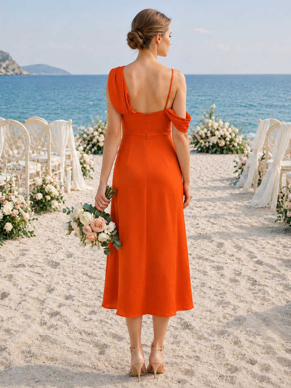 Burnt orange chiffon bridesmaid dress with asymmetric back strap detail, back zipper, and flowing midi-length skirt