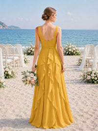 Back view of a marigold chiffon floor-length bridesmaid dress with wide straps, open back, center back zipper, fitted waist, cascading back ruffles, and flowing A-line skirt.