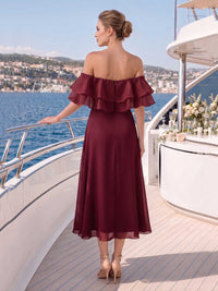 Back view of a burgundy chiffon midi bridesmaid dress with off-shoulder organza ruffle neckline, center back zipper, fitted waist, and softly flowing A-line skirt.