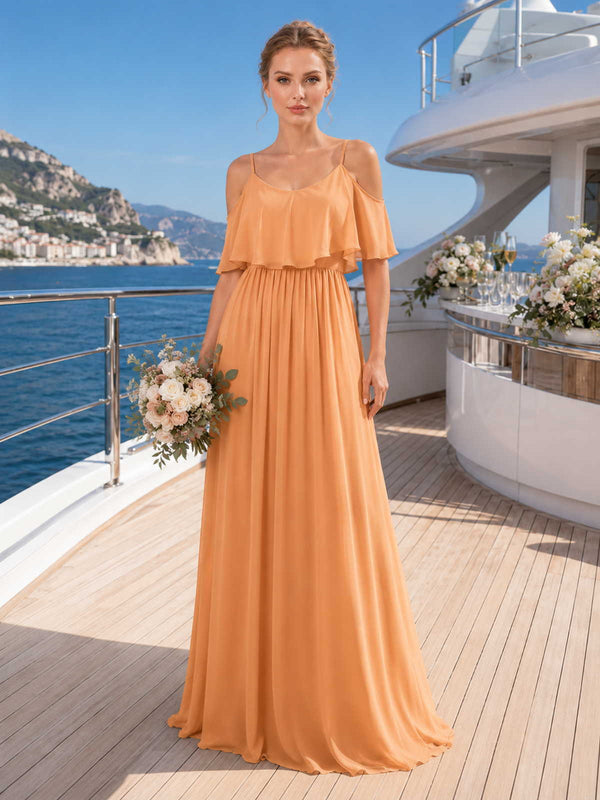 Front view of a soft peach chiffon floor-length bridesmaid dress with scoop neckline, spaghetti straps, cold shoulder flutter sleeves, ruffle overlay bodice, gathered waist, and flowing A-line skirt.