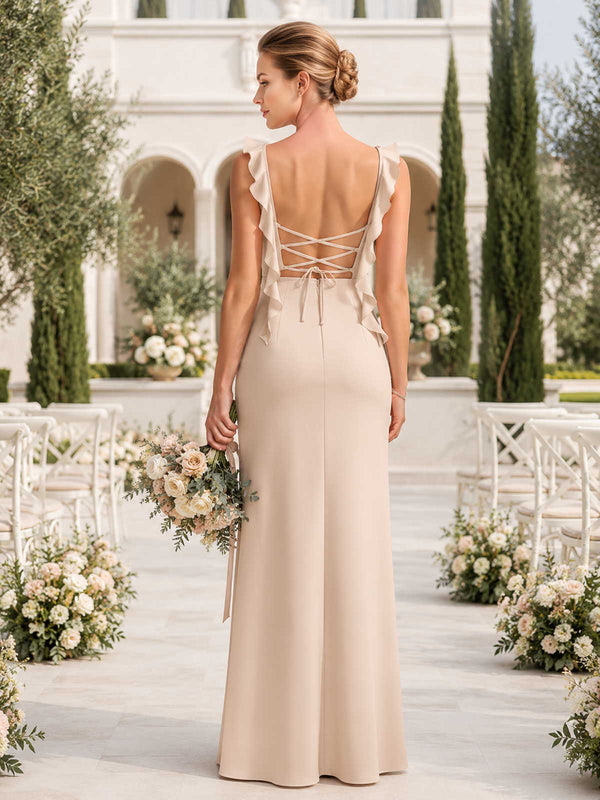 Back view of a champagne satin floor-length bridesmaid dress with ruffle straps, lace-up open back, tie detail, fitted waist, and elegant sheath skirt.