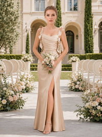 Front view of a champagne satin floor-length bridesmaid dress with square neckline, ruffle straps, ruched bodice, fitted waist, front slit, and elegant sheath skirt.