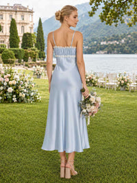 Back view of a light blue satin ankle-length bridesmaid dress with spaghetti straps, straight back neckline, white lace trim, softly gathered upper bodice, fitted silhouette, and fluid sheath skirt.