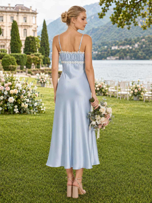 Back view of a light blue satin ankle-length bridesmaid dress with spaghetti straps, straight back neckline, white lace trim, softly gathered upper bodice, fitted silhouette, and fluid sheath skirt.