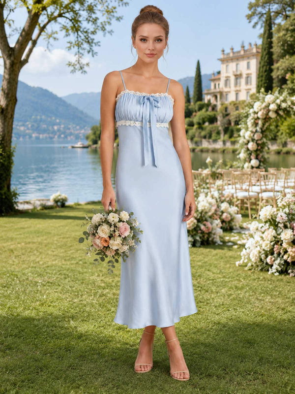 Front view of a light blue satin ankle-length bridesmaid dress with gathered square neckline, spaghetti straps, white lace trim, ruched bust, front tie detail, and elegant sheath skirt.