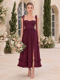 Front view of a burgundy chiffon midi bridesmaid dress with sweetheart neckline, tie shoulder straps, fitted bodice, gathered A-line skirt, front slit, and tiered ruffle hem.