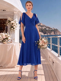 Front view of a royal blue chiffon midi bridesmaid dress with V-neckline, surplice bodice, cold shoulder flutter sleeves, fitted waist, and flowing A-line skirt.