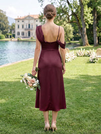 Back view of a burgundy satin midi bridesmaid dress with an asymmetrical shoulder design, slim strap, low back, back zipper, fitted waist, and elegant flowing A-line silhouette.
