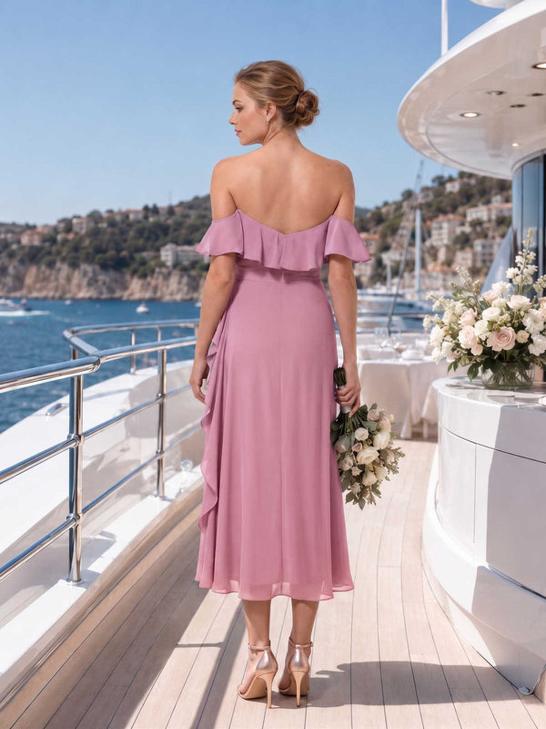 Back view of a dusty rose chiffon midi bridesmaid dress with an off-shoulder ruffle neckline, fitted waist, smooth back bodice, and flowing A-line skirt with soft drape.