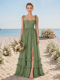 Front view of a sage green chiffon floor-length bridesmaid dress with sweetheart neckline, self-tie shoulder straps, structured fitted bodice, gathered waist, front slit, tiered ruffle hem, and flowing A-line skirt.