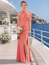Front view of a coral chiffon floor-length bridesmaid dress with cross-front halter neckline, center keyhole detail, fitted bodice, high side slit, and sleek flowing sheath skirt.