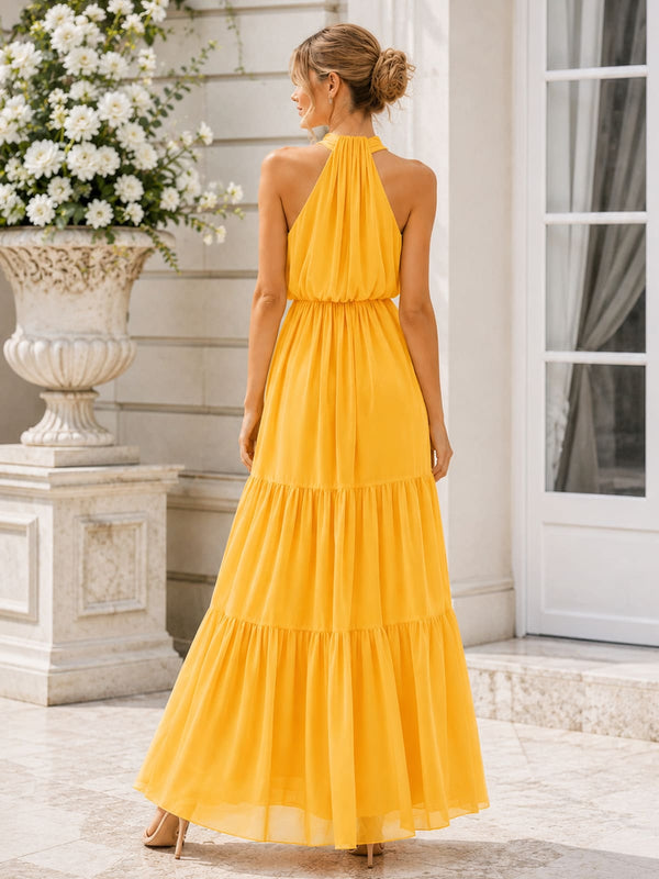 Back view of a marigold chiffon floor-length bridesmaid dress featuring a gathered halter back neckline, sleeveless silhouette, softly defined waist, and a flowing tiered A-line skirt with elegant movement.