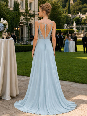 Back view of a muted aqua chiffon floor-length bridesmaid dress featuring slim spaghetti straps, a dramatic deep open back, sheer floral lace side panels, delicate upper-back tie detail, center-back closure, and a flowing A-line chiffon skirt.