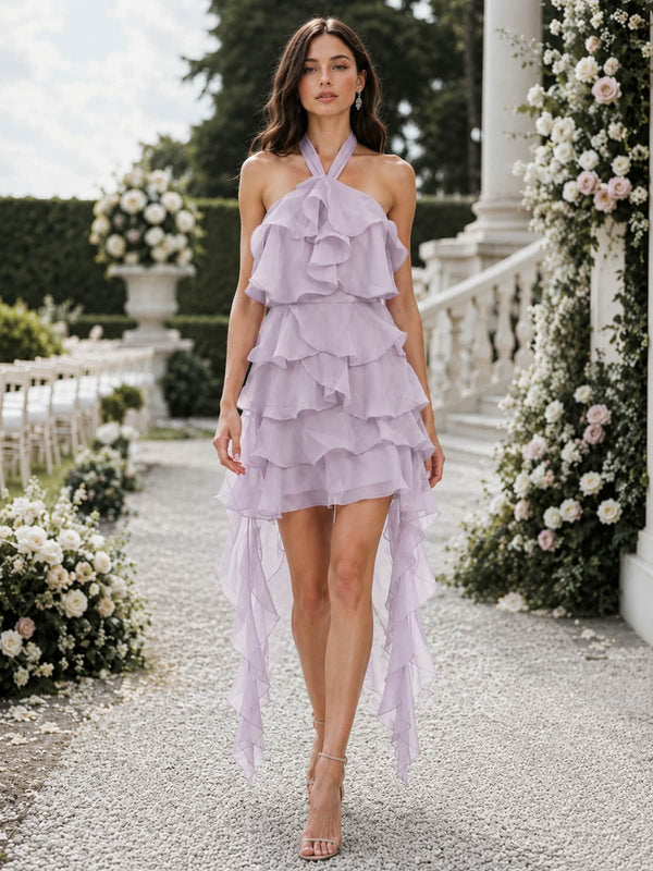 Front view of a lilac chiffon high-low bridesmaid dress featuring a crossed halter neckline, cascading layered bodice ruffles, tiered A-line skirt, short front hem, and long flowing ruffle panels at both sides.