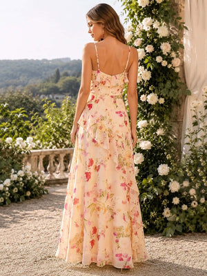 Back view of a floral chiffon floor-length bridesmaid dress featuring slim adjustable spaghetti straps, a fitted straight-back bodice, center-back zipper, cascading ruffle detailing along the side and back, and a flowing A-line skirt.