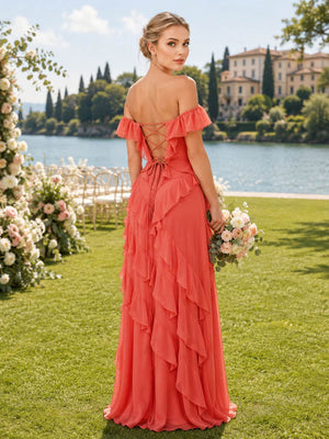 Back view of a coral chiffon floor-length bridesmaid dress featuring an off-the-shoulder ruffled neckline, open lace-up back with crisscross ties, fitted silhouette, and cascading layered chiffon ruffles.