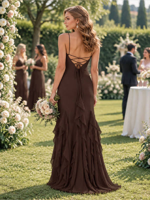 Back view of a chocolate brown chiffon floor-length bridesmaid dress featuring slim spaghetti straps, an open lace-up back with crisscross tie detailing, fitted waist and hips, and a flowing mermaid skirt with cascading layered chiffon ruffles.