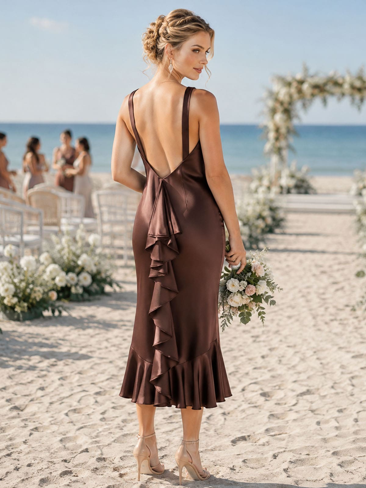 Back view of a brown imitation silk bridesmaid dress featuring a dramatic deep V-back, wide shoulder straps, fitted mermaid silhouette, cascading vertical back ruffle detail, and softly flared midi hem.