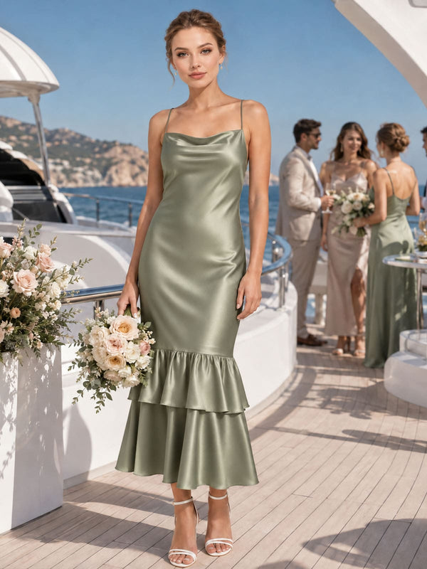 Front view of a sage green imitation silk midi bridesmaid dress featuring delicate spaghetti straps, a softly draped cowl neckline, fitted sheath silhouette, lustrous satin-like finish, and elegant tiered ruffle hem.