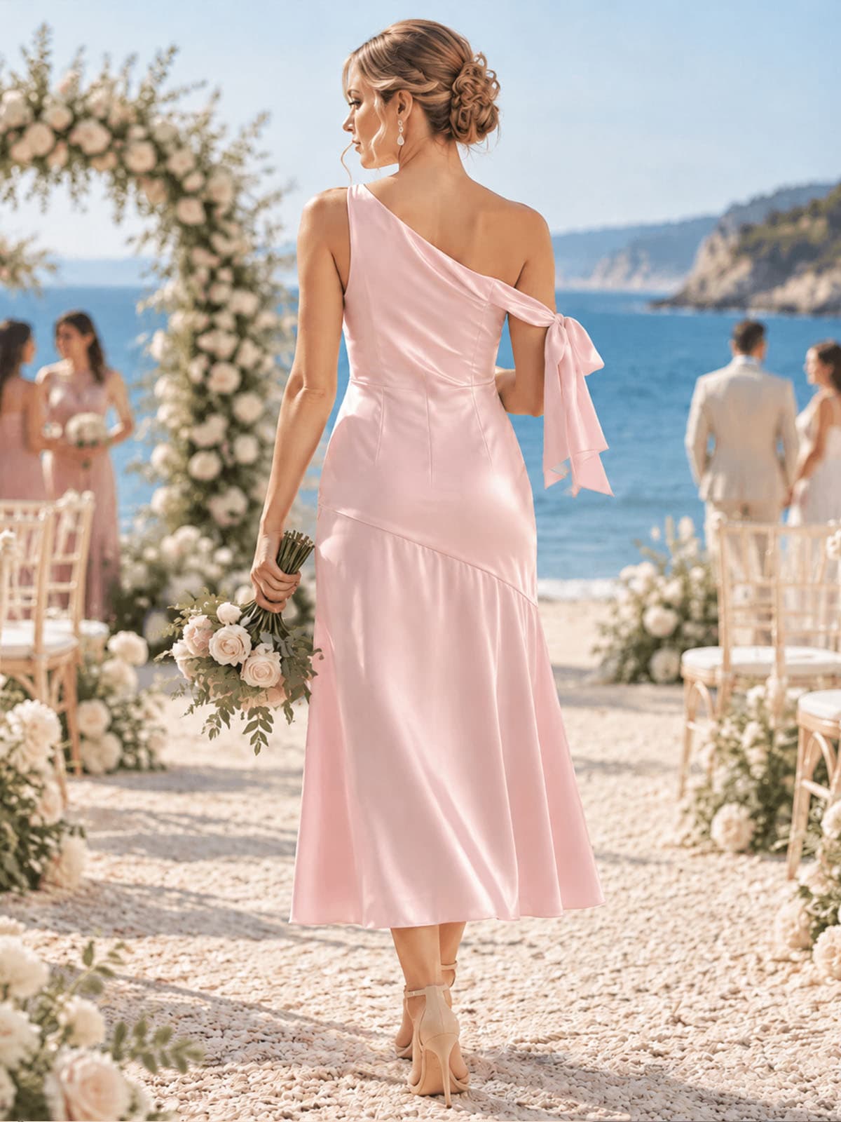 Back view of a light pink imitation silk bridesmaid dress featuring a one-shoulder back design, shoulder bow detail, fitted bodice, softly flared tea-length skirt, and elegant asymmetrical silhouette.
