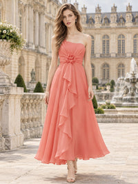 Coral chiffon one-shoulder tea-length bridesmaid dress with floral rosette and cascading ruffle, front view.
