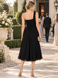 Black chiffon one-shoulder midi bridesmaid dress with floral shoulder strap, fitted waist and concealed back zipper, back view.