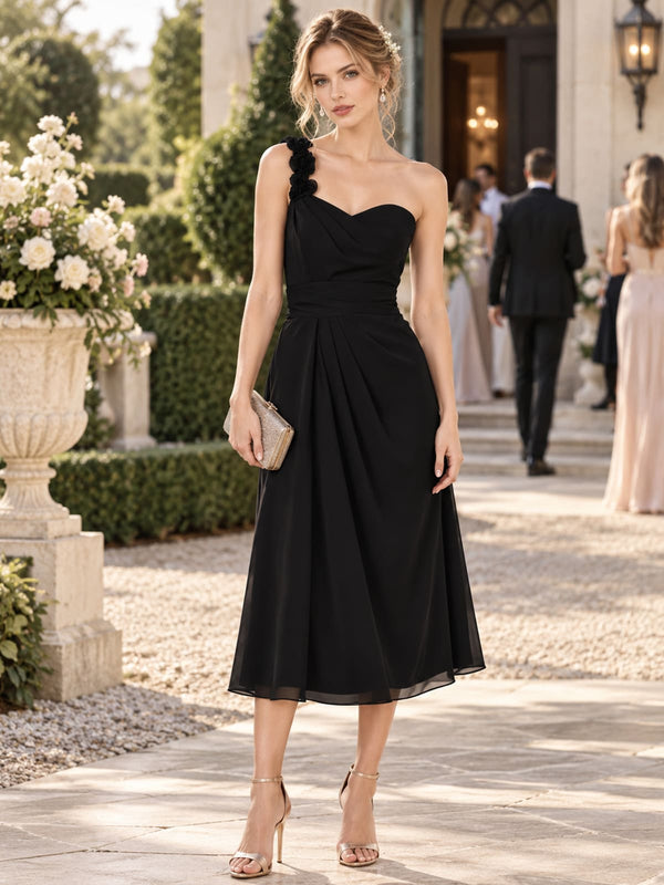 Black chiffon one-shoulder midi bridesmaid dress with floral shoulder detail and ruched bodice, front view.