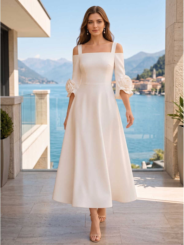 Ivory satin A-line square-neck tea-length evening dress front view with open-shoulder sleeves and floral cuff appliques