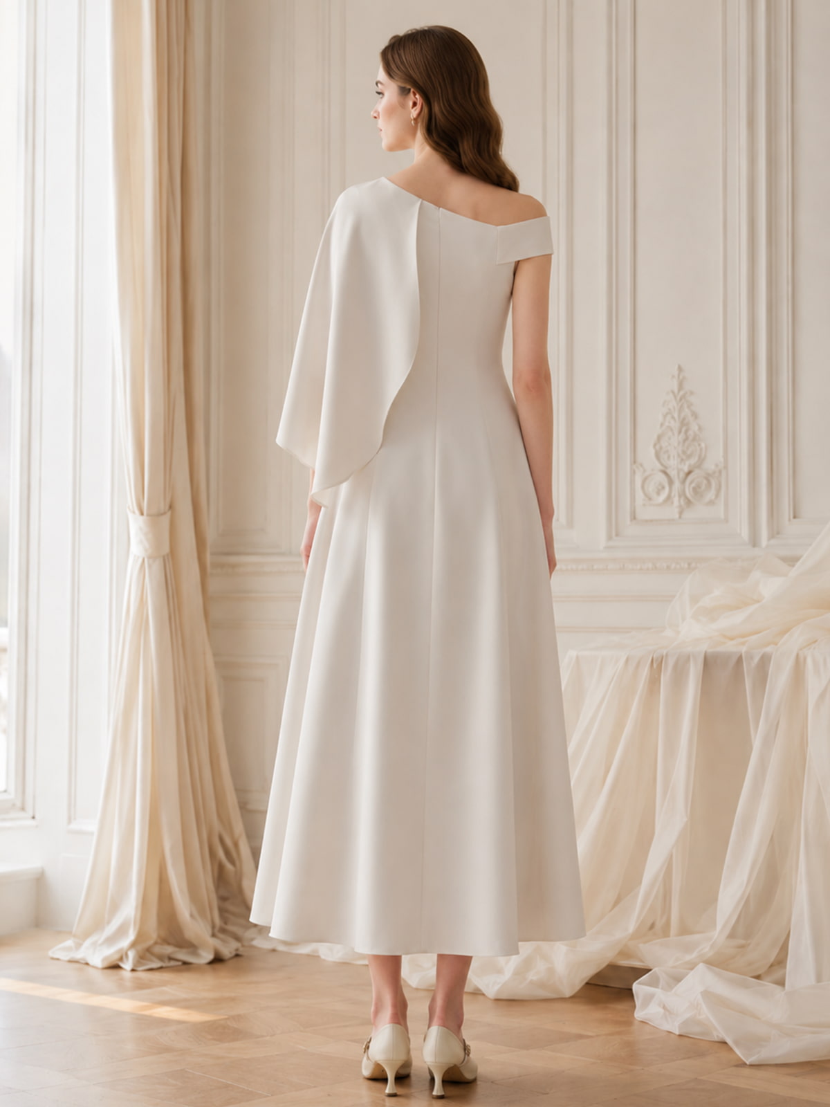 Satin one shoulder midi length evening dress back view with cape overlay detail