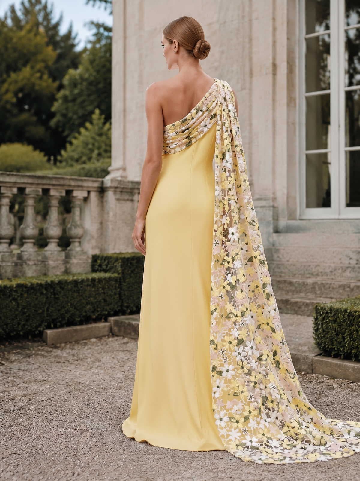 Floral one shoulder floor length evening dress back view with draped cape overlay