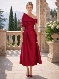 Satin off shoulder midi length mother of the bride evening dress front view with draped shoulder bow detail