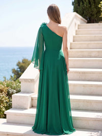 Green chiffon mother of the bride dress back view with one shoulder cape detail, concealed zipper, flowing A-line skirt, and floor length silhouette