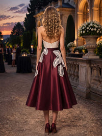 Satin mother of the bride dress back view with strapless bodice, concealed back zipper, contrast lace applique detail, and tea length A-line skirt