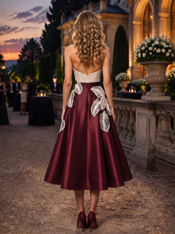 Satin mother of the bride dress back view with strapless bodice, concealed back zipper, contrast lace applique detail, and tea length A-line skirt