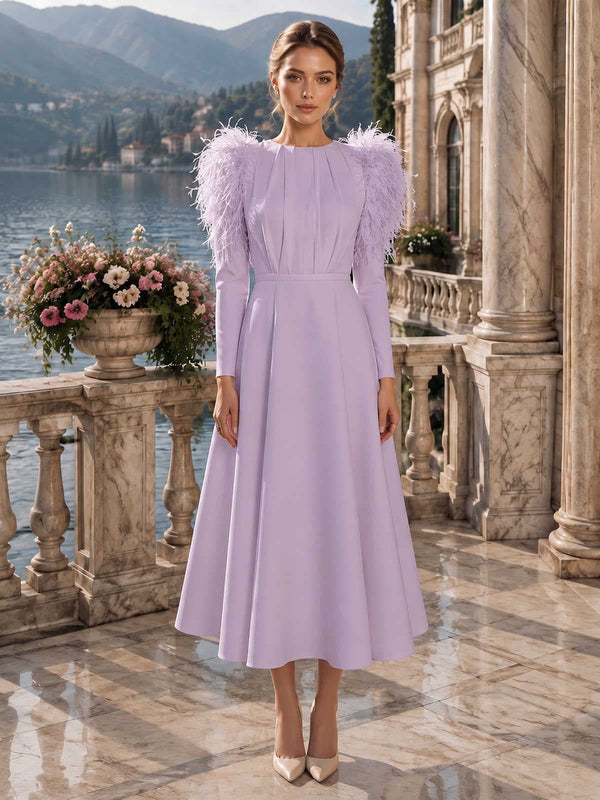 Satin mother of the bride dress front view with round neckline, long sleeves, feather shoulder detail, fitted waist, and tea length A-line skirt