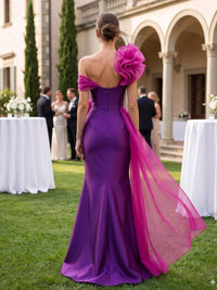 Satin mother of the bride dress back view with off-shoulder neckline, sculptural shoulder ruffle, concealed back zipper, fitted mermaid silhouette, and flowing sheer sash
