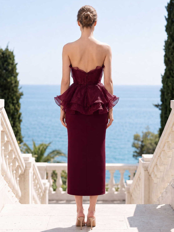 Burgundy satin organza mother of the bride dress back view with strapless bodice, concealed back zipper, layered organza peplum, and tea length slim skirt