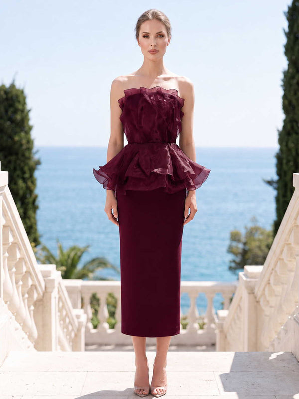 Burgundy satin organza mother of the bride dress front view with strapless neckline, layered peplum ruffle, fitted bodice, and tea length slim skirt